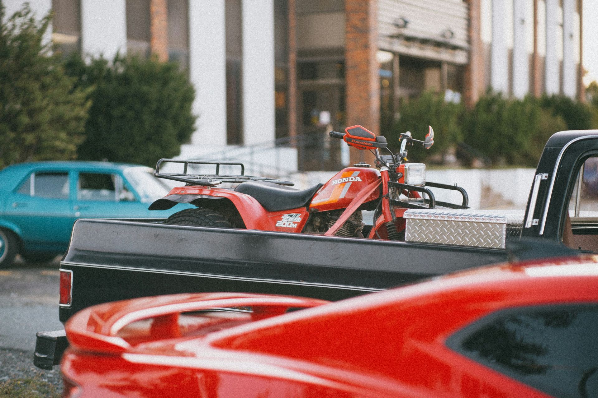 red and black motorcycle parked on the side of the road